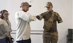  ?? — AFP ?? Valery Kucherenko (left), greets veteran of the Russian-ukrainian war Mykola Voronchuk at the Protez Foundation in Kyiv on April 2, 2024.