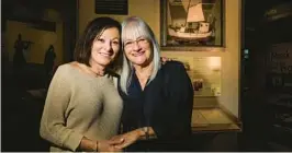  ?? DIRK SHADD/TAMPA BAY TIMES ?? Margot Benstock, 68, left. and Irene Weiss, 69, pose in front of a scale model replica of a fishing boat on exhibit behind them at the Florida Holocaust Museum. Benstock’s parents escaped the Holocaust by fleeing Denmark on a fishing boat.