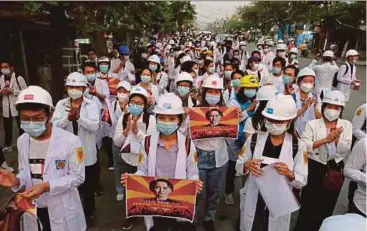  ?? AFP PIC ?? Medical staff and students taking part in an early morning protest against the military coup and crackdown by security forces on demonstrat­ions, in Mandalay yesterday.