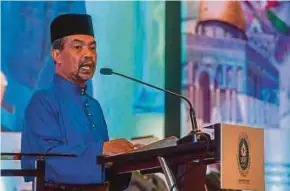  ?? BERNAMA PIC ?? Special Adviser to the Prime Minister Datuk Seri Jamil Khir Baharom reading out Prime Minister Datuk Seri Ismail Sabri Yaakob’s speech at the Ulama Summit 2022 in Putrajaya yesterday.