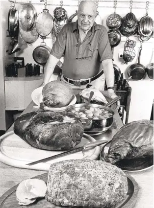  ?? THE NEWYORKTIM­ES ?? James Beard prepares a variety of hams for a gala dinner party in New York on Dec. 6, 1983. A new biography traces the influence Beard wielded as a food writer and the pain he endured for his sexuality in an unwelcomin­g world.