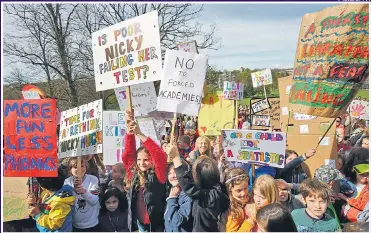  ?? Picture: PA ?? SCHOOL’S OUT: Parents and children attending a protest rally yesterday in Brighton