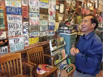  ?? BILL BARROW — THE ASSOCIATED PRESS ?? In this photo, Anthony Pham, talks in his Monroe, Ga., barber shop. He became a U.S citizen in 1987, five years after he immigrated from Vietnam. Now a business owner and proud Republican in Georgia’s staunchly conservati­ve 10th Congressio­nal District,...