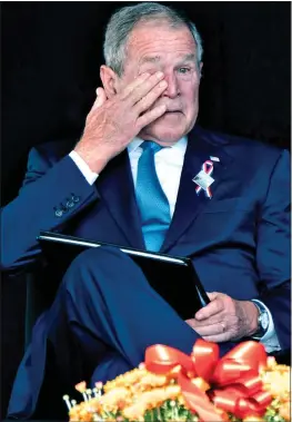  ??  ?? OVERCOME: Former President George W. Bush in tears at a ceremony in Shanksvill­e, Pennsylvan­ia. Right: Lights in New York mark where the twin towers stood