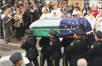  ?? Spencer Platt / Getty Images ?? The casket of retired NYPD detective Luis Alvarez is brought out of a church in New York City. Alvarez became a national figure fighting for health benefits for police, firefighte­rs and others.