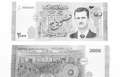 ??  ?? A portrait of Syria’s President Bashar al-Assad is seen printed on the new Syrian 2,000pound bank note that went into circulatio­n. — Reuters photo