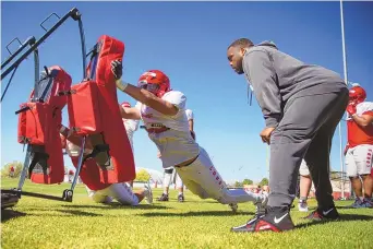  ?? JON AUSTRIA / JOURNAL ?? UNM defensive linemen Joe Ray Maez, left, and Max Elkman, right, push a sled during practice Thursday at the UNM Football East Practice Fields.