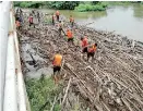  ??  ?? Garbage and cut bamboos heaped up on the banks of Gin Ganga