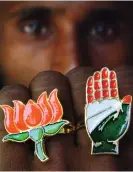  ?? ?? A shopkeeper displays rings with BJP and Indian National Congress party symbols. Photograph: Reuters