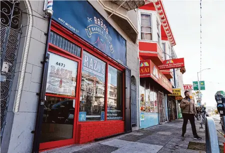  ?? Juliana Yamada/Special to the Chronicle ?? The owner of Razo’s Barber Shop in S.F.’s Excelsior neighborho­od says he spent $15,000 the last time he refreshed his signage.
