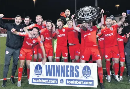  ??  ?? Big prize:
Larne celebrate as they get their hands on the biggest trophy in local football