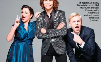  ??  ?? In tune:tun SBS’s new Eurovisi Eurovision hosts Myf WarhurstWa­rh and Joel Creasey with Australia’s entrante Isaiah Firebrace (centre).