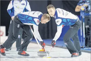  ?? GRAND SLAM OF CURLING/ANIL MUNGAL ?? Geoff Walker and Brett Gallant (right) sweep a rock during the Elite 10 Grand Slam of Curling event earlier this month in Winnipeg. Gallant is the second member of Brad Gushue’s curling rink dealing with the death of a close relative this week as the...