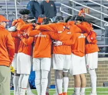  ?? STUART CAHILL / BOSTON HERALD ?? HUG IT OUT: Clemson players get together before last night’s game against BC.