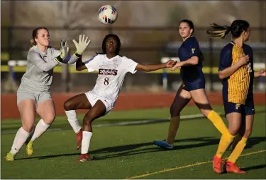  ?? MATTHEW JONAS — STAFF PHOTOGRAPH­ER ?? Erie’s Nonso Uwalaka, right, and Frederick’s Elaina Leither, left, nearly collide after a corner kick on April 7.