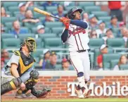  ?? Brett davis-usa Today sports ?? Atlanta Braves second baseman Ozzie Albies hits a grand slam against the Pittsburgh Pirates in the seventh inning at Truist Park on Saturday.