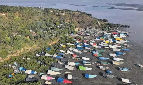  ?? Picture: REUTERS/FRANCIS MASCARENHA­S/FILE PHOTO ?? An aerial view of fishing boats covered with tarpaulin sheets parked on the shore, before the start of the monsoon season, on the outskirts of Mumbai, India, June 8, 2023.