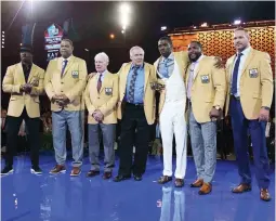  ?? (Reuters) ?? MEMBERS OF the Pro Football Hall of Class of 2018 (from left) Brian Dawkins, Robert Brazile, Bobby Beathard, Jerry Kramer, Randy Moss, Ray Lewis and Brian Urlacher (inductee Terrell Owens did not attend the ceremony) pose with their gold jackets during...