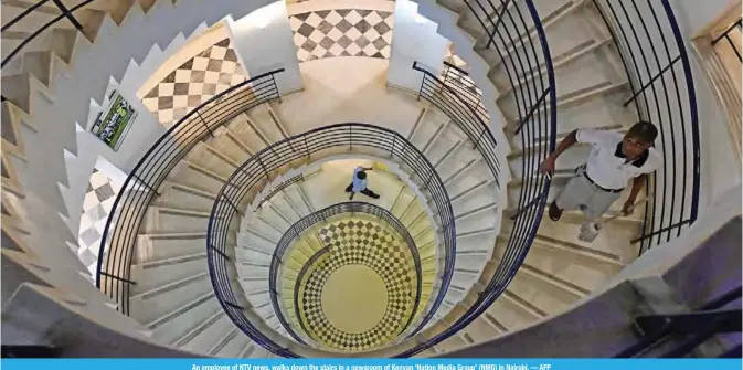  ??  ?? An employee of NTV news, walks down the stairs in a newsroom of Kenyan ‘Nation Media Group’ (NMG) in Nairobi. — AFP
