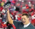  ?? GREGORY BULL/AP ?? Tom Brady, 43, hoists the Super Bowl trophy he and his Tampa Bay Buccaneers won on Sunday. He and LeBron James have formed a mutual admiration society.