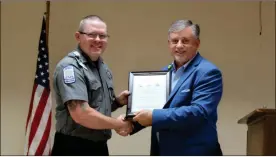  ?? Olivia Morley ?? Floyd Medical EMS Director Bud Owens (right) presents EMS Lt. Dusty Johnson with a Frontline Award Monday for his work as a paramedeic and mentoring new EMTS. Johnson is also the Georgia Region 1 Paramedic of the Year.