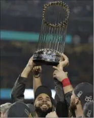  ?? DAVID J. PHILLIP - THE ASSOCIATED PRESS ?? Boston Red Sox’s David Price holds the championsh­ip trophy after Game 5 of baseball’s World Series against the Los Angeles Dodgers on Sunday, Oct. 28, 2018, in Los Angeles. The Red Sox won 5-1 to win the series 4 game to 1.