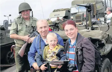  ??  ?? Family affair The McCurdie clan from Ayr, Robert and Annette with son Robert, meet Grant Davidson of the Scottish Military Vehicle Group
070915 Airshow_ 10