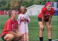  ?? BRIAN FISHER - FOR THE NEWS-HERALD ?? Mentor’s Alyssa Blackburn and Abby Piks pose with Sydney, a first-grader at Bellflower Elementary School, prior to the Cardinals’ “Kick for the Cure” match Sept. 18against visiting Lake Catholic. Sydney is undergoing chemothera­py for a Stage 3tumor and was a primary honoree for this year’s event.