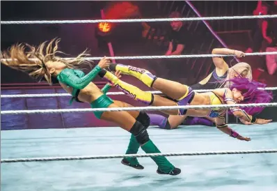  ?? PHILIPPE HUGUEN AGENCE FRANCE-PRESSE ?? Wrestlers Alicia Fox (left) and Sasha Bank battle during the WWE show at Zenith Arena on Tuesday in Lille, northern France.