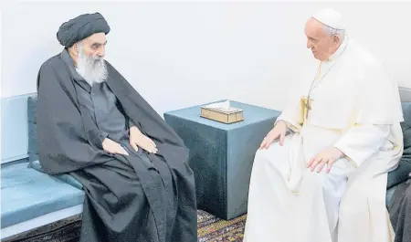  ?? VATICAN MEDIA ?? Pope Francis, right, meets Saturday with Iraq’s leading Shiite cleric, Grand Ayatollah Ali al-Sistani, in Najaf, Iraq. Their meeting at al-Sistani’s home was the first between a pope and a grand ayatollah.