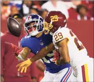  ?? Alex Brandon / Associated Press ?? Washington Football Team cornerback Kendall Fuller (29) stops New York Giants wide receiver Kenny Golladay from catching the ball during the second half of Thursday’s game.