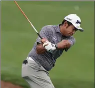  ?? (AP/Charlie Riedel) ?? Hideki Matsuyama hits on the driving range before a practice round Tuesday in preparatio­n for the Masters in Augusta, Ga. Matsuyama is seeking to be the first golfer to successful­ly defend his Masters title since Tiger Woods in 2002.