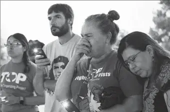  ?? KAYLEE GREENLEE BEAL / REUTERS ?? Andrea Osorio leans on Maria Victoria de la Cruz as she cries during a vigil on Tuesday for migrants who were found dead inside a trailer truck in Texas.