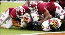  ?? CHRIS SZAGOLA — THE ASSOCIATED PRESS ?? Maryland running back Anthony McFarland Jr. (5) is stopped short of the goal line by Temple defensive end Zack Mesday, left, and linebacker Shaun Bradley, right, during the second half.