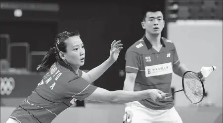  ?? GETTY IMAGES ?? Mixed doubles pair Zheng Siwei(right) and Huang Yaqiong, pictured in action during June’s Olympic tuneup competitio­n in Chengdu, Sichuan province, spearhead China’s gold-medal hopes in badminton at the Tokyo Olympics.