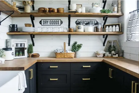  ??  ?? |ABOVE| ALL IN THE DETAILS.The white shiplap from The Rustic Collection and the butcher block countertop give the pantry its farmhouse foundation. Brass pulls add a moderntouc­h.