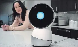  ?? STEVEN SENNE THE ASSOCIATED PRESS ?? Massachuse­tts Institute of Technology robotics researcher Cynthia Breazeal and social robot Jibo. Jibo can swivel its flat, round screen face to meet your gaze. It tells jokes and and plays music.