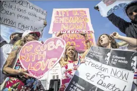  ?? ZACH GIBSON / NEWYORKTIM­ES ?? Demonstrat­ors gatherMond­ay outside the newly opened Cuban Embassy inWashingt­on. Cuban Foreign Minister Bruno Rodríguez raised his country’s flag outside of the embassy and called for the dismantlin­g of the economic embargo.