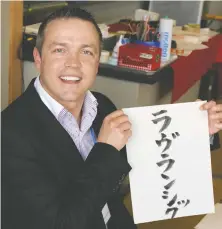  ?? KATHY SHANNON ?? Rome Lavrencic, a New Westminste­r French teacher and president of a BCTF languages committee, holds a sign that says his last name in Japanese writing, during a school trip to Japan.