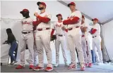  ?? ASSOCIATED PRESS ?? Philadelph­ia Phillies players wait to have their photo taken on Feb. 22 in Clearwater, Fla.