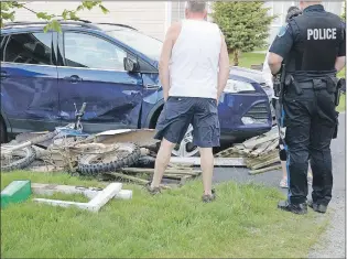  ?? KEITH GOSSE/THE TELEGRAM ?? One man was taken to hospital with what appear to be non-life-threatenin­g injuries following a motorcycle-car collision on North Pond Road in Torbay Sunday evening. It appeared the man lost control of the dirt bike he was riding and struck both a mailbox and garbage box before colliding with a parked car. The Royal Newfoundla­nd Constabula­ry is investigat­ing the incident. To see more photos and video, go to www.thetelegra­m.com