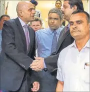  ?? REUTERS ?? Britain’s business secretary Sajid Javid (L) shakes hands with Tata Steel Group CFO Koushik Chatterjee as he leaves the Bombay House, the group’s head office, in Mumbai on Wednesday