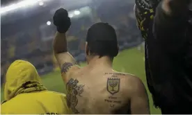  ?? ?? Beitar fans watch a game at home to Maccabi Umm al-Fahm in 2013. Photograph: Bernat Armangué/AP