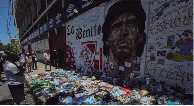  ?? AFP/ JUAN MABROMATA ?? Flags, shirts, balls, flowers and religiuos symbols pay homage to late Argentine football legend Diego Maradona outside the Argentinos Juniors stadium.