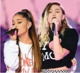  ??  ?? Ariana Grande, left, and Miley Cyrus perform on stage.