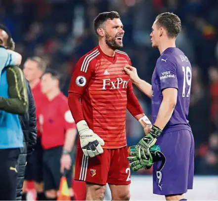  ?? — Reuters ?? I feel for you: Arsenal goalkeeper Bernd Leno (right) talking to his Watford counterpar­t Ben Foster after the Premier League match at Vicarage Road on Monday.