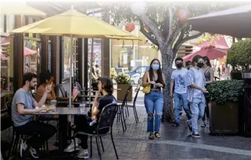  ?? HANS GUTKNECHT — STAFF PHOTOGRAPH­ER ?? People walk through Los Angeles' Little Tokyo neighborho­od, perhaps headed to some of the eateries included on the walking tours of the Delicious Little Tokyo event. Pastries, miso and rice bowls are some of the flavors along the way.