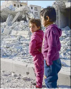  ?? AFP ?? Young children stand in a destroyed street after soldiers recapture Al-Bab town from terrorist group Islamic State on Thursday.