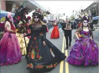  ?? ?? Mario Saucedo, center, and his sisters Julissa Saucedo Hearn and Yolanda Saucedo, right, lead the parade of Catrinas through downtown Vallejo to the Day of the Dead celebratio­n on Saturday.