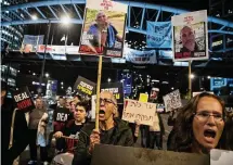  ?? ?? People hold signs and photos of hostages during a protest calling for a hostage deal Thursday in Tel Aviv, Israel.